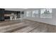Bright and airy living room open to kitchen featuring wood-look tile flooring at 6434 N 17Th St, Phoenix, AZ 85016