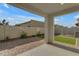 Covered patio with brick accents, artificial turf, and block wall fencing for an enjoyable outdoor space at 6434 N 17Th St, Phoenix, AZ 85016