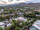 Panoramic aerial view of the neighborhood showcasing the lush greenery, homes, and mountain backdrop at 6611 N 64Th Pl, Paradise Valley, AZ 85253