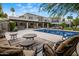 Expansive backyard featuring a pool, lounge area, and covered patio, perfect for entertaining at 6611 N 64Th Pl, Paradise Valley, AZ 85253