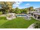 Lush backyard with a fountain, pool, and covered seating area offering a serene outdoor space at 6611 N 64Th Pl, Paradise Valley, AZ 85253