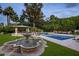 Stunning backyard showcasing a fountain, lush greenery, pool, and a charming gazebo seating area at 6611 N 64Th Pl, Paradise Valley, AZ 85253