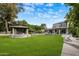 Expansive backyard with a gazebo, fountain, pool, and lush green lawn; perfect for outdoor living at 6611 N 64Th Pl, Paradise Valley, AZ 85253