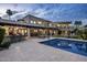 Expansive backyard featuring a pool, lush lawn, covered patio with an outdoor kitchen, and a fountain at 6611 N 64Th Pl, Paradise Valley, AZ 85253