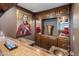 Home bar with wooden cabinetry, decorative glassware, and unique artwork at 6611 N 64Th Pl, Paradise Valley, AZ 85253