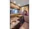 Home bar featuring a copper sink, marble countertops, and wood cabinetry at 6611 N 64Th Pl, Paradise Valley, AZ 85253