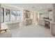 Elegant bathroom boasting a soaking tub, dual vanities, and a make up counter at 6611 N 64Th Pl, Paradise Valley, AZ 85253