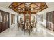 Elegant dining room features a coffered ceiling, chandelier, marble floors, and large artwork at 6611 N 64Th Pl, Paradise Valley, AZ 85253