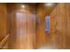 Elevator with wood paneling showing the second floor with a traditional call button and controls for easy access at 6611 N 64Th Pl, Paradise Valley, AZ 85253
