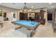 Bright game room featuring a billiards table under a decorative chandelier and access to an adjacent office space at 6611 N 64Th Pl, Paradise Valley, AZ 85253