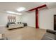 Large garage area, with a car lift, featuring sofas and modern art on the walls, offering a versatile space at 6611 N 64Th Pl, Paradise Valley, AZ 85253