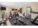 Home gym with a variety of exercise equipment and padded flooring at 6611 N 64Th Pl, Paradise Valley, AZ 85253