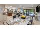 Spacious kitchen with a marble table and view of the backyard and pool at 6611 N 64Th Pl, Paradise Valley, AZ 85253