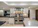 Modern kitchen featuring an oversized Viking cooktop, granite countertops and custom cabinetry at 6611 N 64Th Pl, Paradise Valley, AZ 85253