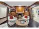 Living room features a fireplace, built-in shelving, and comfortable chairs at 6611 N 64Th Pl, Paradise Valley, AZ 85253