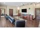 Cozy living room featuring a wet bar, plush seating, and sleek dark wood flooring at 6611 N 64Th Pl, Paradise Valley, AZ 85253