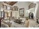 Bright, open living room featuring a chandelier, balcony, neutral decor, and a cozy seating area at 6611 N 64Th Pl, Paradise Valley, AZ 85253