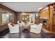 Elegant living room with a fireplace, built-in shelving, and comfortable armchairs at 6611 N 64Th Pl, Paradise Valley, AZ 85253
