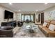 Living room with comfortable seating, a modern coffee table, and a large television at 6611 N 64Th Pl, Paradise Valley, AZ 85253