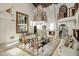 Open living room with grand fireplace, soaring ceilings, chandelier, and balcony overlooking at 6611 N 64Th Pl, Paradise Valley, AZ 85253