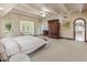 Spacious main bedroom featuring a bay window, beamed ceilings, and carpeted floor at 6611 N 64Th Pl, Paradise Valley, AZ 85253