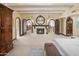 Spacious main bedroom with a fireplace, beamed ceilings and arched doorways leading to the upper floors at 6611 N 64Th Pl, Paradise Valley, AZ 85253