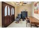 Cozy home office with a ceiling fan, comfortable leather chair, and modern wooden desk; perfect for working from home at 6611 N 64Th Pl, Paradise Valley, AZ 85253