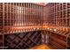 A well-organized wine cellar with wooden racks, featuring bottles and ambient lighting at 6611 N 64Th Pl, Paradise Valley, AZ 85253