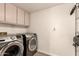 Efficient laundry room with modern washer and dryer set and ample storage cabinets at 7604 N 46Th Ave, Glendale, AZ 85301