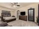 Relaxing main bedroom with a fan, dresser and door leading to the main bath at 7604 N 46Th Ave, Glendale, AZ 85301