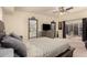 Serene main bedroom with a ceiling fan, large dresser, and views to the outside patio at 7604 N 46Th Ave, Glendale, AZ 85301