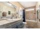Bathroom with tile accents, built-in tub, and large framed mirror at 7807 E Main St # Cc-71, Mesa, AZ 85207
