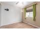 Empty bedroom with wood-look floors and a large window at 7807 E Main St # Cc-71, Mesa, AZ 85207