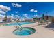 Hot tub and inviting community pool with sun loungers and dining, surrounded by well-maintained landscaping, creating a relaxing atmosphere at 7807 E Main St # Cc-71, Mesa, AZ 85207
