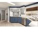 Updated kitchen with stainless steel dishwasher, stainless steel sink, and blue lower cabinets at 7807 E Main St # Cc-71, Mesa, AZ 85207
