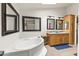 Bathroom features a large tub, double sink vanity, and tiled flooring at 8111 E 5Th Ave, Mesa, AZ 85208