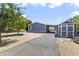 View of the home and driveway with a detached building and carport at 8111 E 5Th Ave, Mesa, AZ 85208