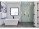 Sleek bathroom with a freestanding tub and separate glass-enclosed shower at 8300 E Dixileta Dr # 306, Scottsdale, AZ 85266