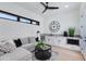 Bright living room with wet bar, comfortable seating, and modern ceiling fan and lighting at 8300 E Dixileta Dr # 306, Scottsdale, AZ 85266