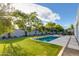 Backyard pool with a manicured lawn, shade structure, and lush landscaping at 8300 E Dixileta Dr # 306, Scottsdale, AZ 85266
