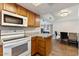 Efficient kitchen design with a microwave over the range and a view into the dining area at 839 S Westwood -- # 154, Mesa, AZ 85210