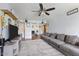 Cozy living room featuring a large sectional sofa, ceiling fan, and open access to the dining area at 839 S Westwood -- # 154, Mesa, AZ 85210
