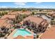 Aerial view showcases a refreshing community pool surrounded by well-maintained buildings and landscaping at 839 S Westwood -- # 154, Mesa, AZ 85210