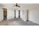 Bedroom featuring unfinished floors, white closet, and ceiling fan at 875 E Flint St, Chandler, AZ 85225
