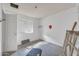 A bedroom with unfinished walls and concrete floors, featuring a window and a door at 875 E Flint St, Chandler, AZ 85225