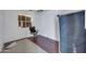 Dilapidated bedroom featuring damaged flooring, boarded window and office chair at 875 E Flint St, Chandler, AZ 85225