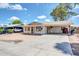 A single-story home features a spacious concrete driveway and a covered front porch with columns at 875 E Flint St, Chandler, AZ 85225