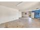 Open living room with concrete floors, unfinished walls, and access to the outdoor area at 875 E Flint St, Chandler, AZ 85225