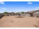 An expansive backyard with gravel, featuring additional structures for storage and utility at 901 E Hearn Rd, Phoenix, AZ 85022