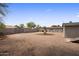 Exterior shot of a spacious backyard with mature trees, offering a versatile area for recreation and relaxation at 901 E Hearn Rd, Phoenix, AZ 85022
